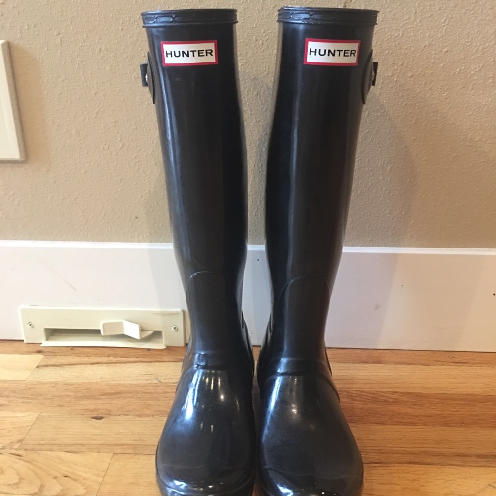 Tall glossy black hunter boots